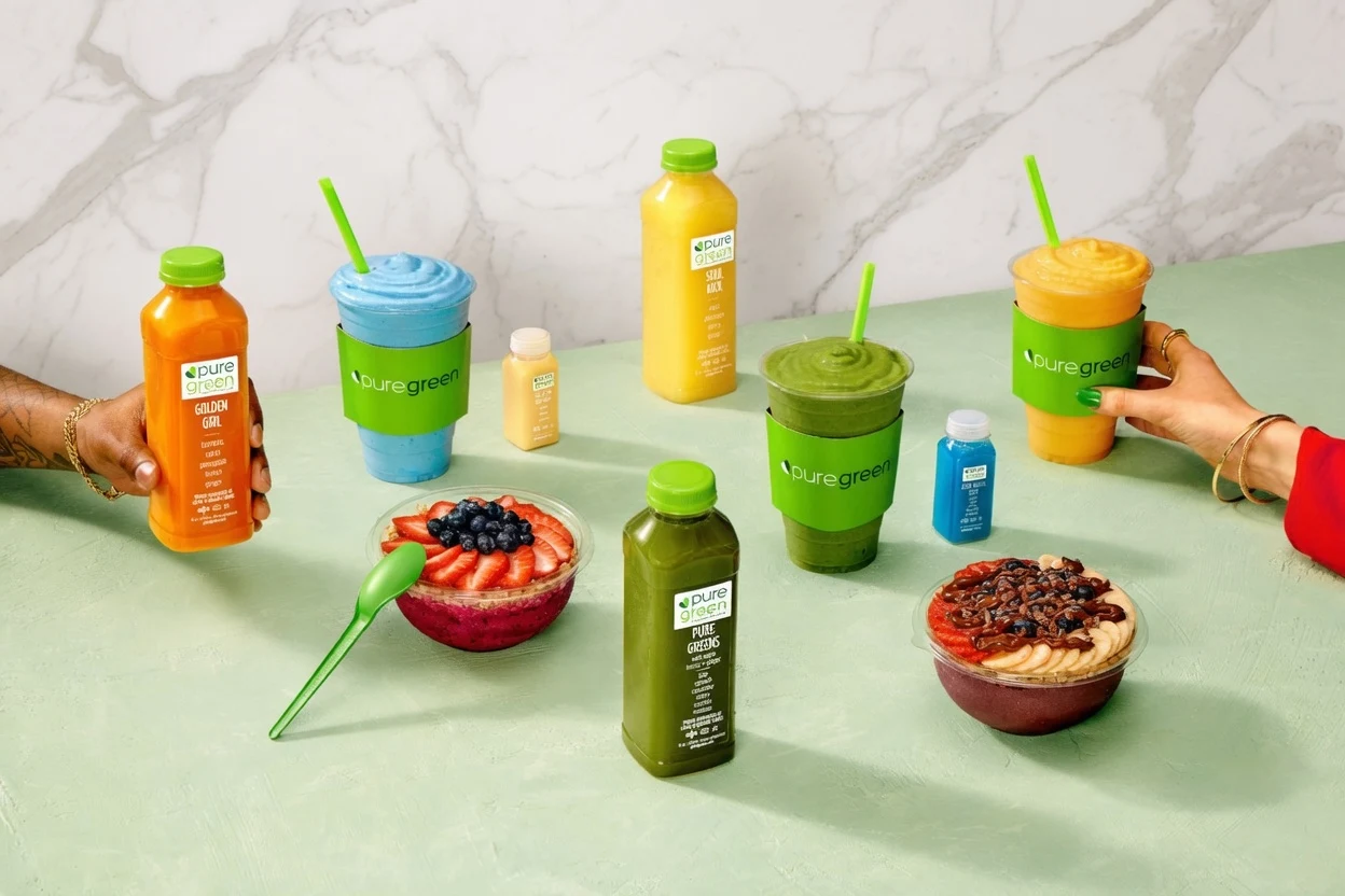 Pure Green smoothies, cold pressed juices, acai bowls and juice shots on a counter