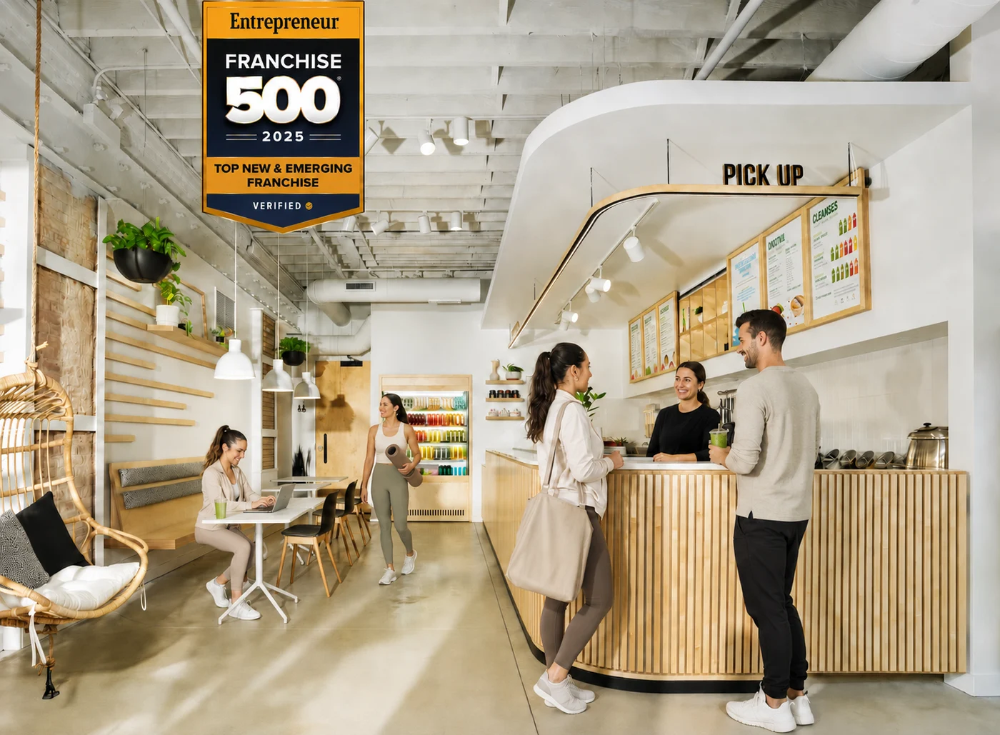 Customers ordering smoothies inside a Pure Green juice bar franchise store, Entrepreneur Franchise 500 2025 Top New & Emerging Franchise