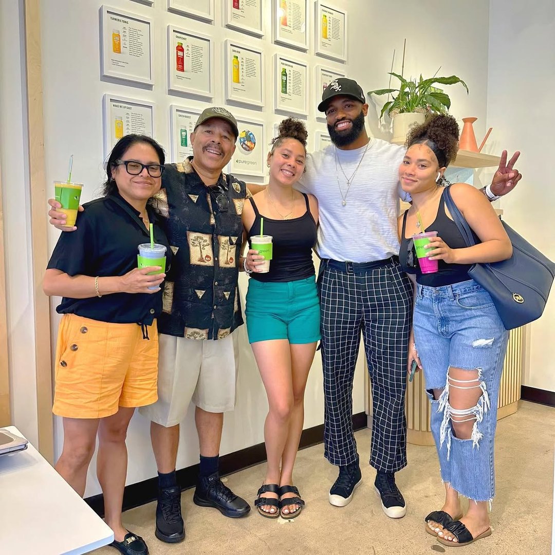 Group of friends holding Pure Green smoothies inside the Arcadia store
