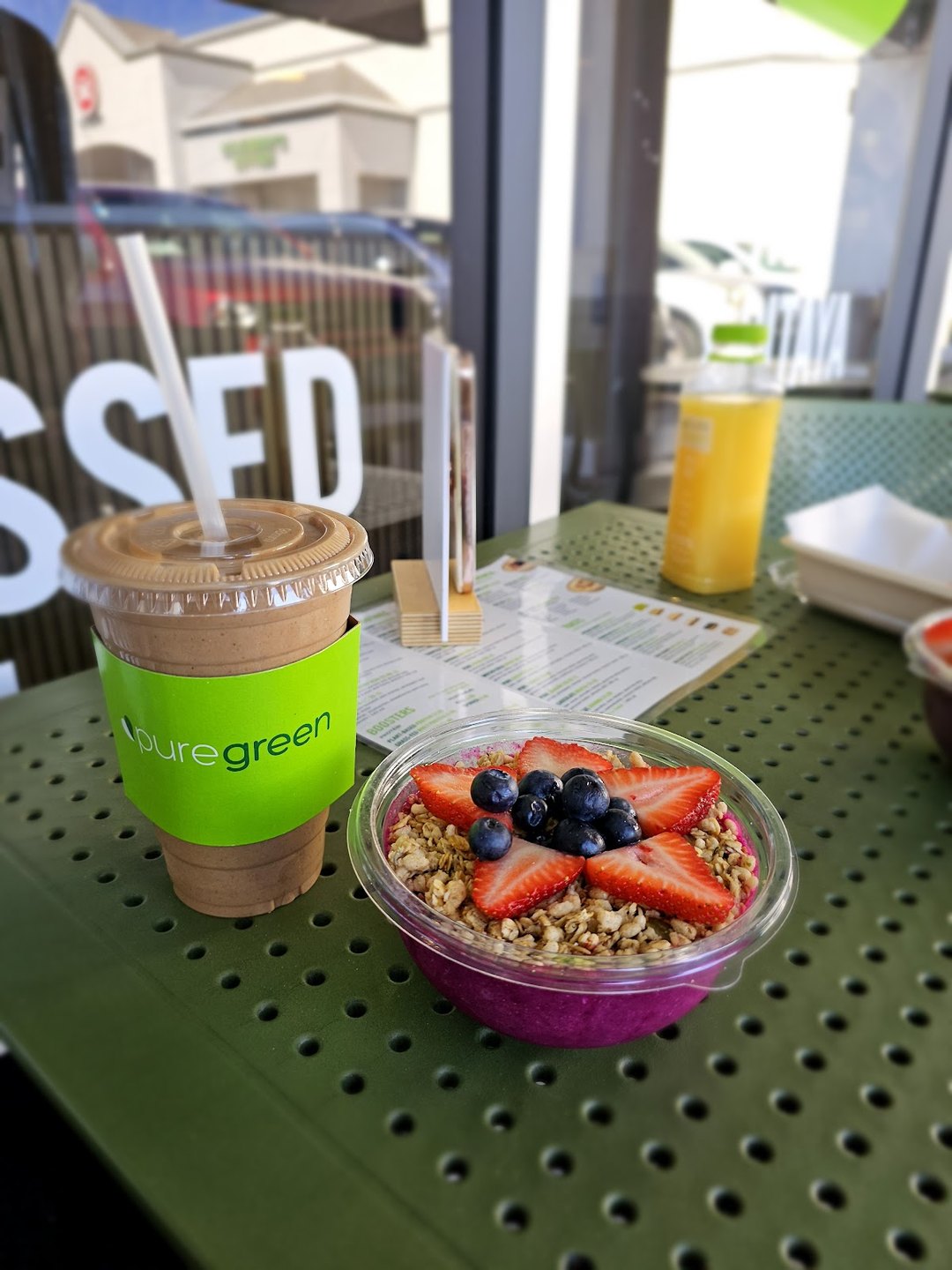 Pure Green smoothie and an acai bowl topped with berries at the Arcadia juice bar