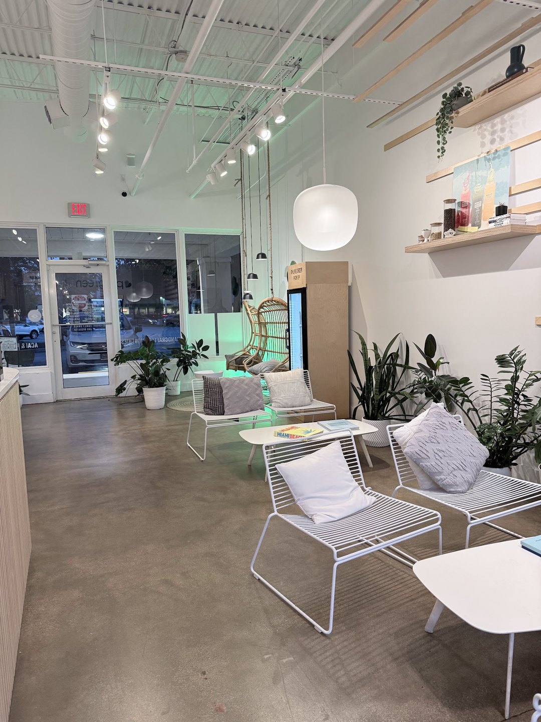 Inside Pure Green Garden Shops Boca Raton with modern seating and plants