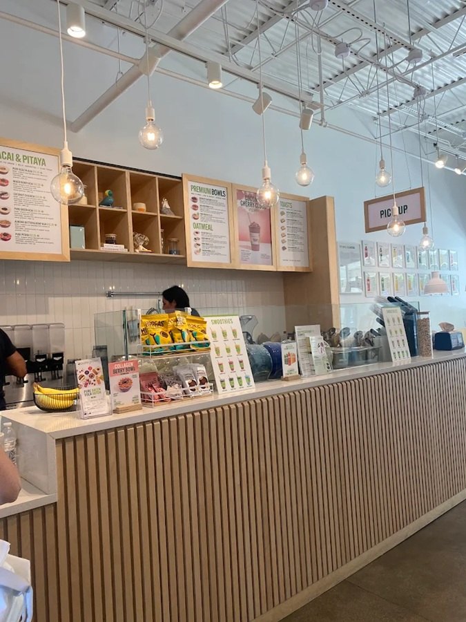 The order counter and menu boards inside Pure Green Garden Shops Boca Raton