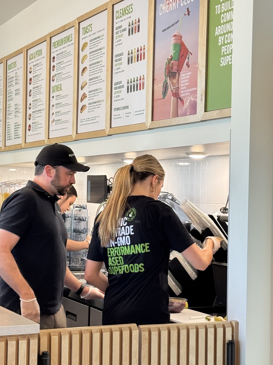 Pure Green Fort Collins team members preparing orders behind the counter