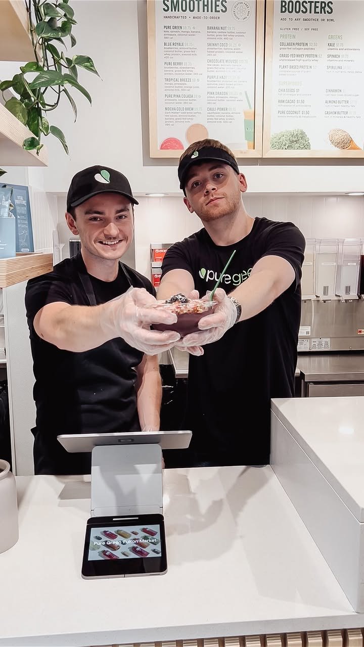 Pure Green Fulton Market staff handing over a freshly made drink at the counter