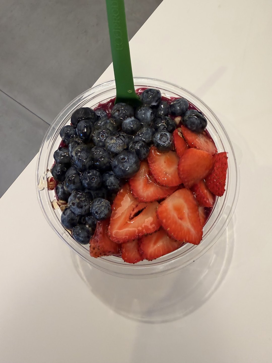 Acai bowl topped with fresh strawberries and blueberries at Pure Green Sawgrass Mills