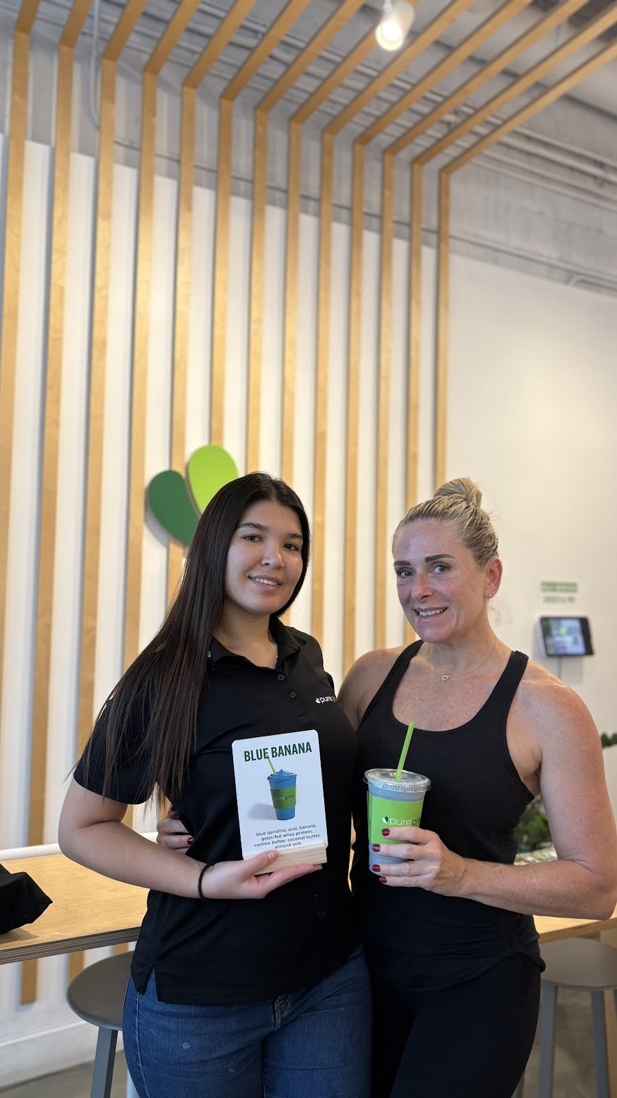 Pure Green Sunset Harbour team members with a fresh green smoothie