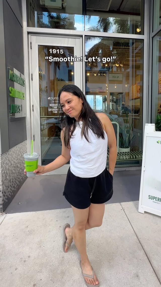 Guest holding a green smoothie at the Pure Green Sunset Harbour entrance