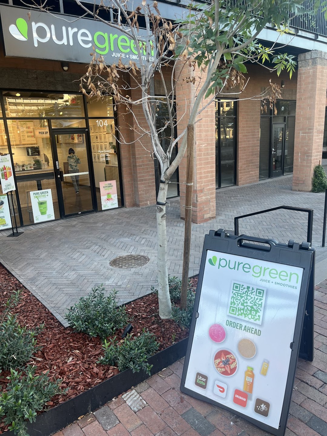 Pure Green Tempe storefront on South Mill Avenue with an A-frame sidewalk sign