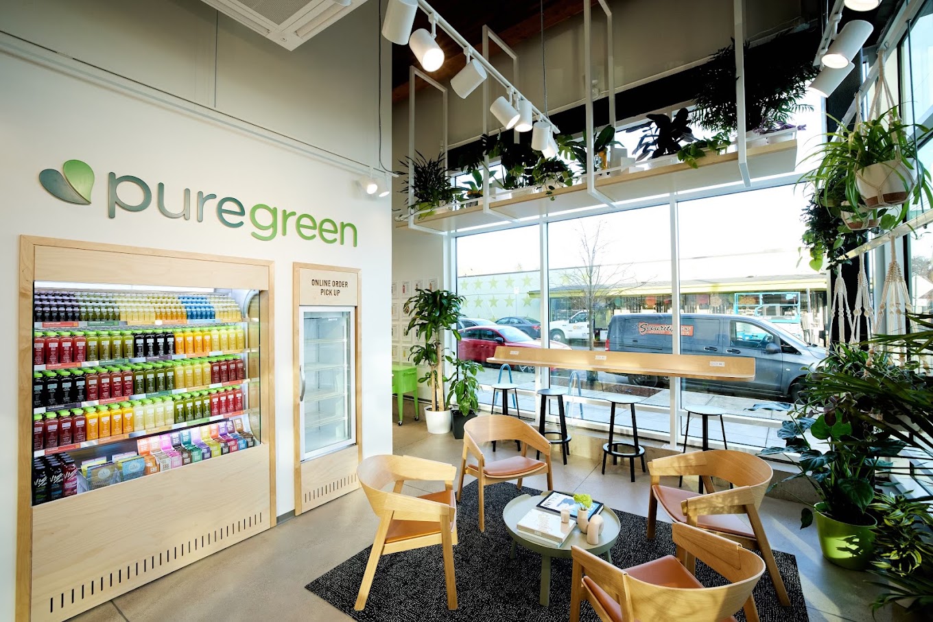 The cold-pressed juice wall and lounge seating inside Pure Green Portland